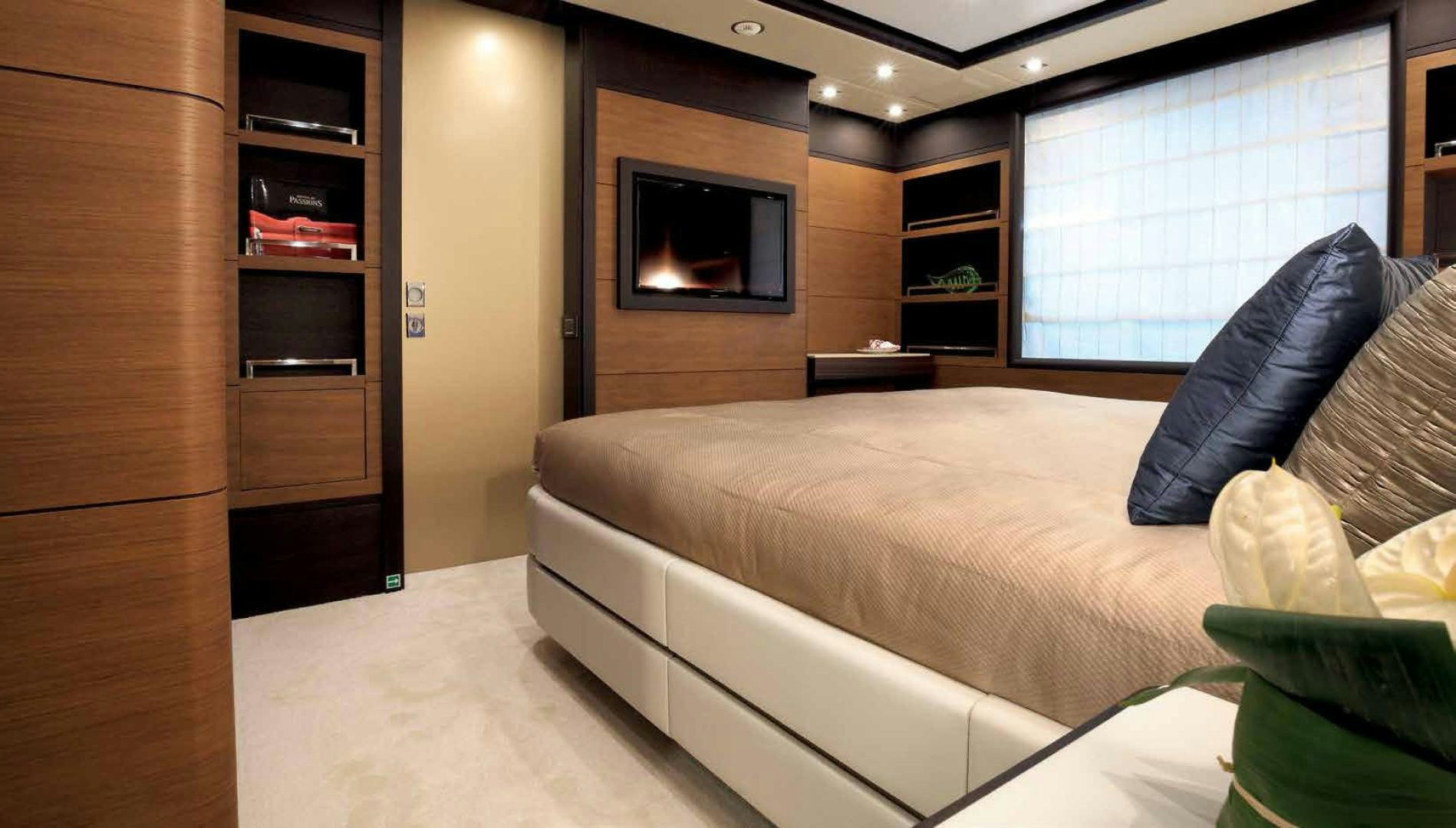 a hotel room with a bed and tv aboard DREW Yacht for Sale