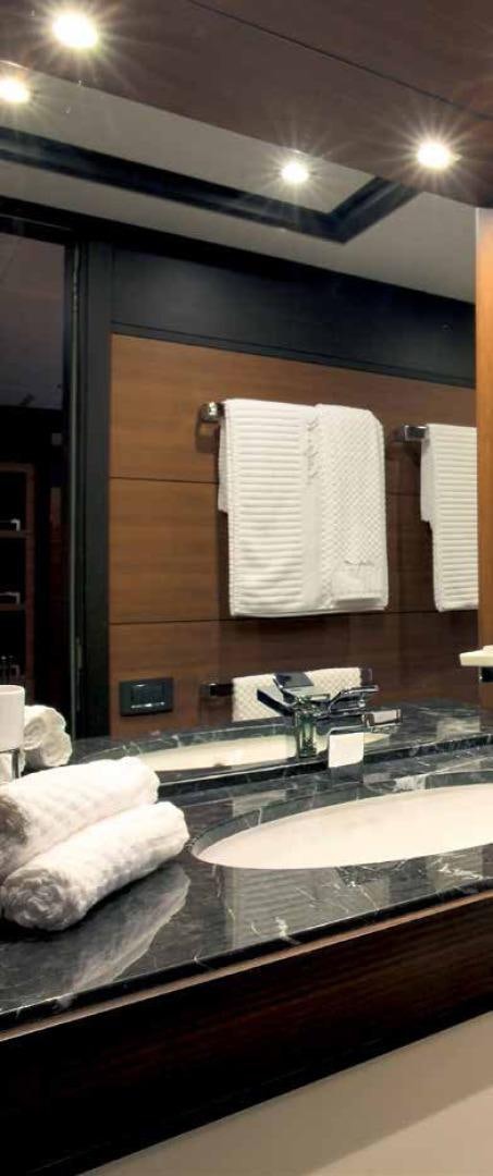 a bathroom with a countertop sink and towels aboard DREW Yacht for Sale