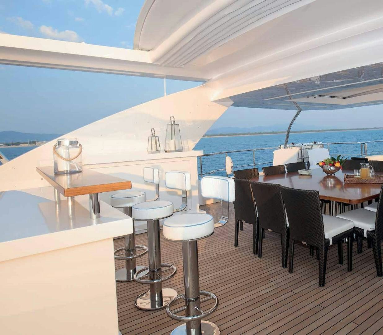 a room with tables and chairs aboard DREW Yacht for Sale