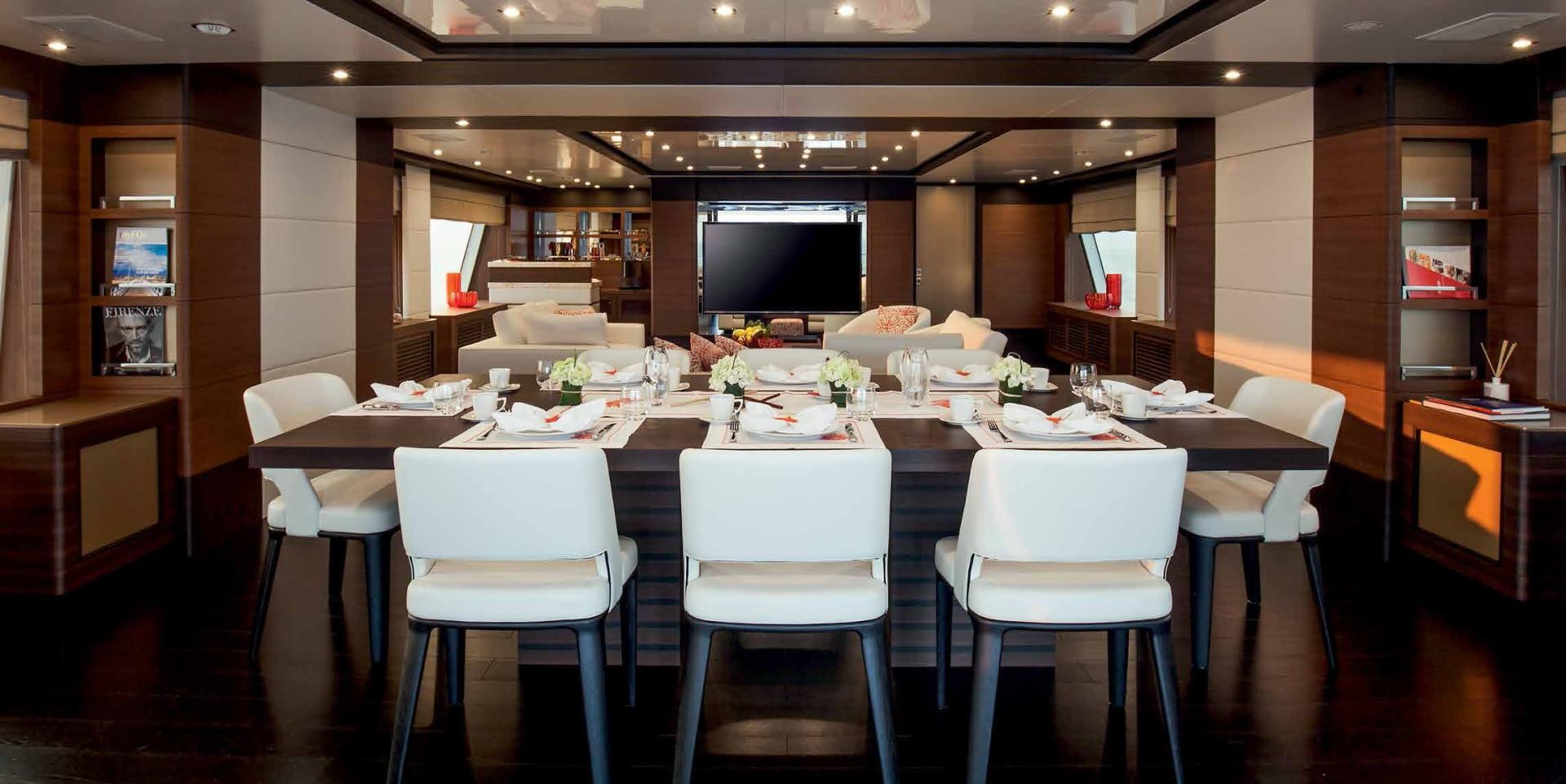 a large room with tables and chairs aboard DREW Yacht for Sale