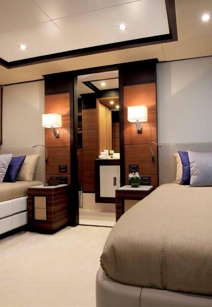 a hotel room with a bed and a mirror aboard DREW Yacht for Sale