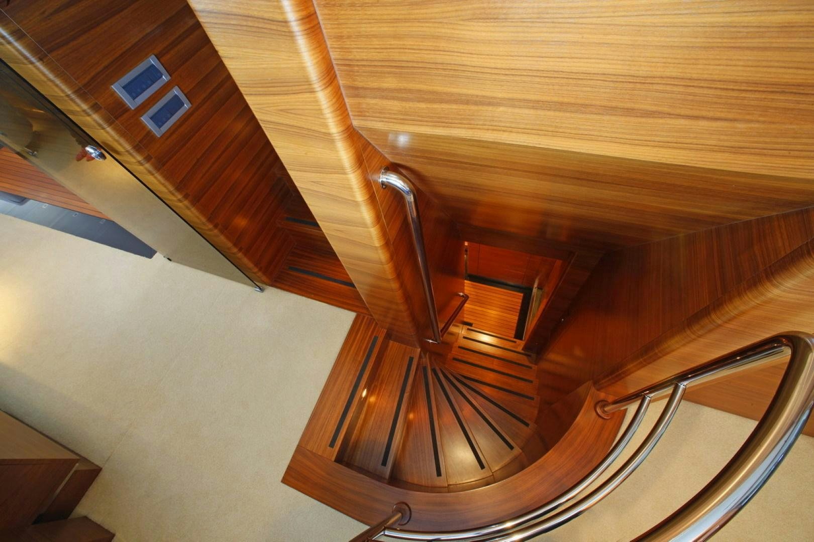 a wooden staircase with a spiral staircase aboard MR MOUSE Yacht for Sale
