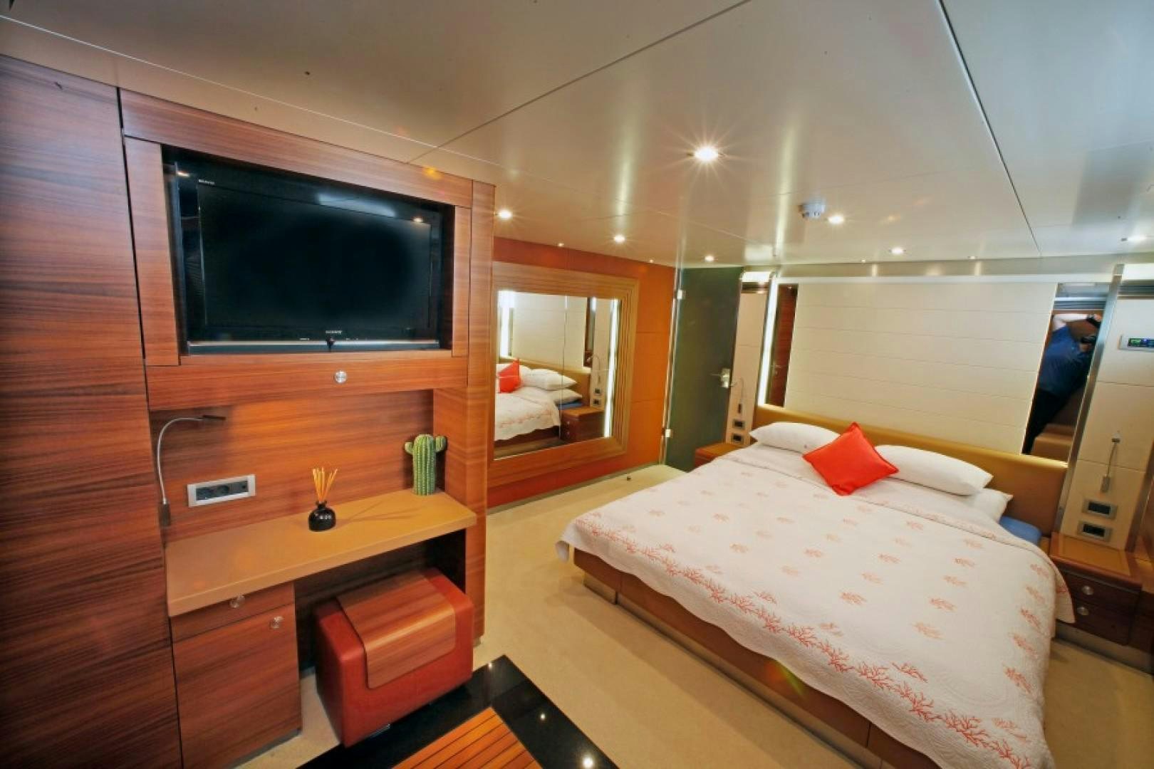 a bedroom with a bed and tv aboard MR MOUSE Yacht for Sale