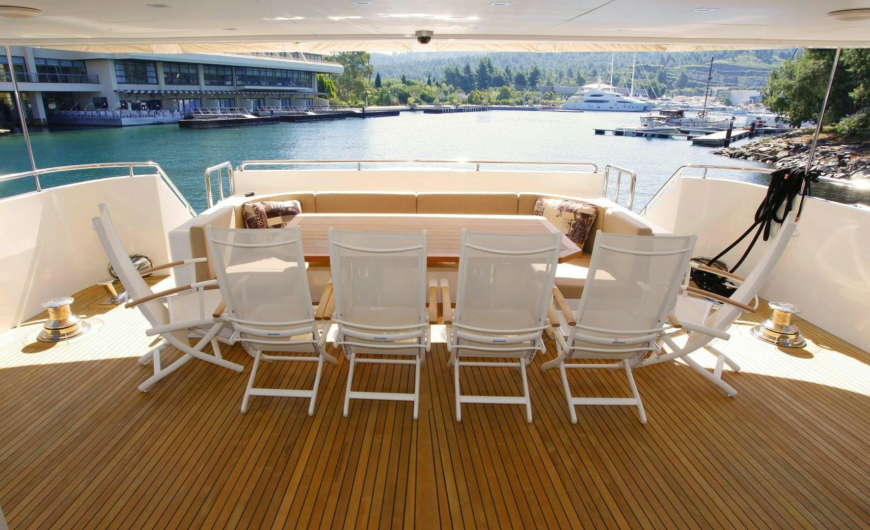 a table and chairs on a deck aboard MR MOUSE Yacht for Sale