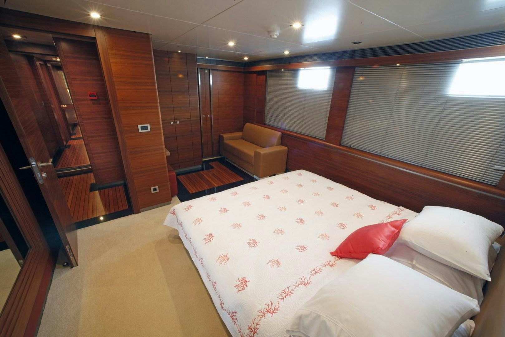 a room with a bed and a chair aboard MR MOUSE Yacht for Sale