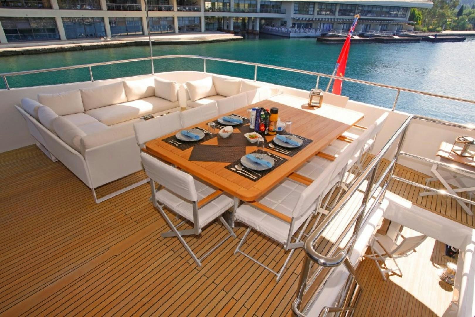 a table and chairs on a deck aboard MR MOUSE Yacht for Sale