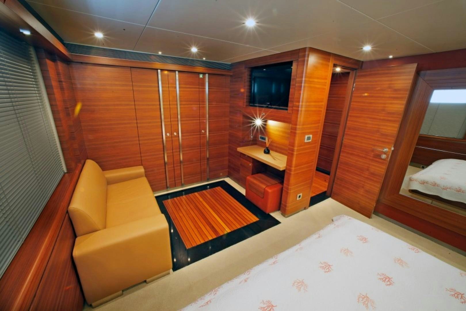 a room with a bed and a chair aboard MR MOUSE Yacht for Sale