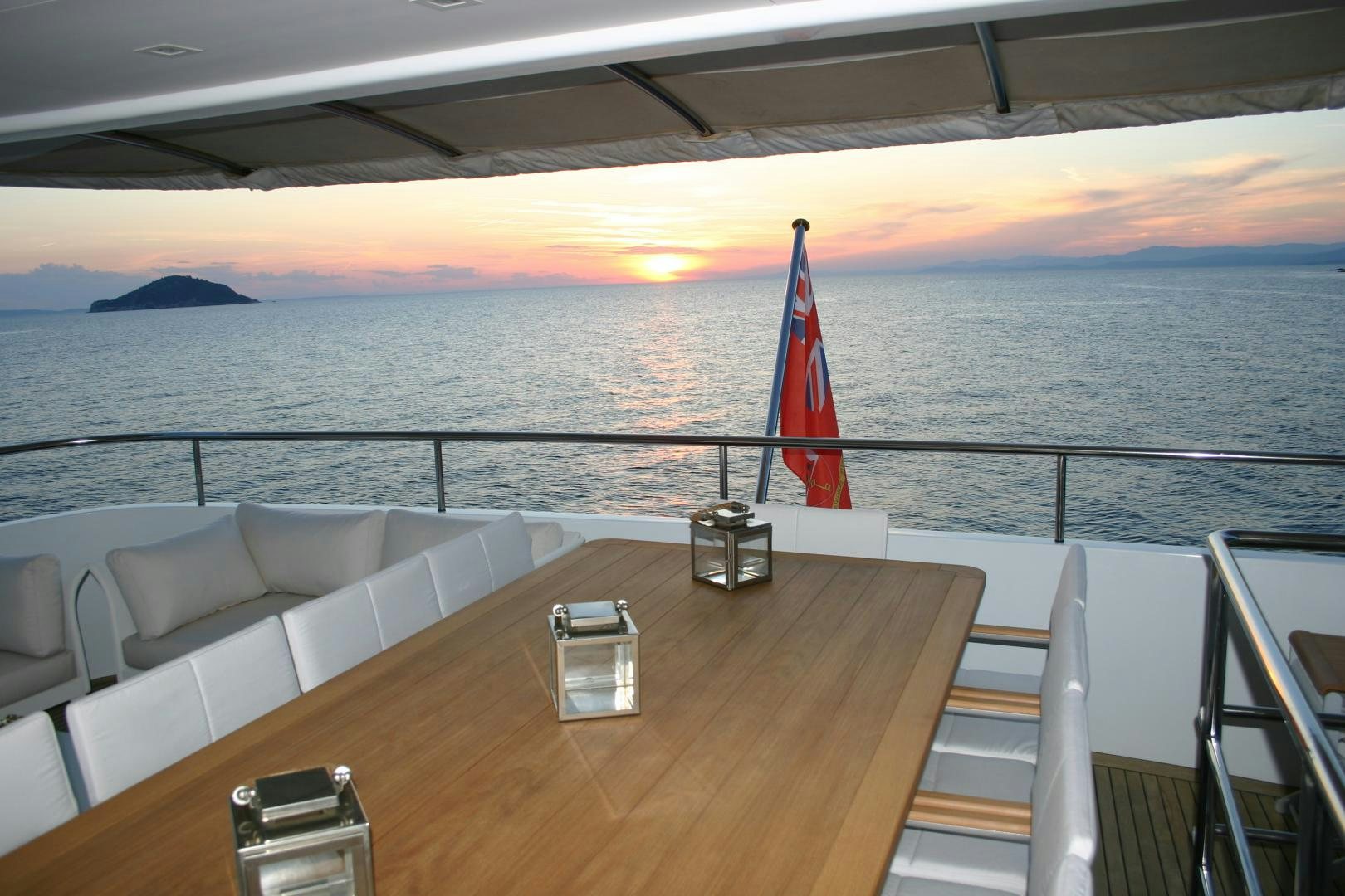 a deck with a chair and a table on it aboard MR MOUSE Yacht for Sale