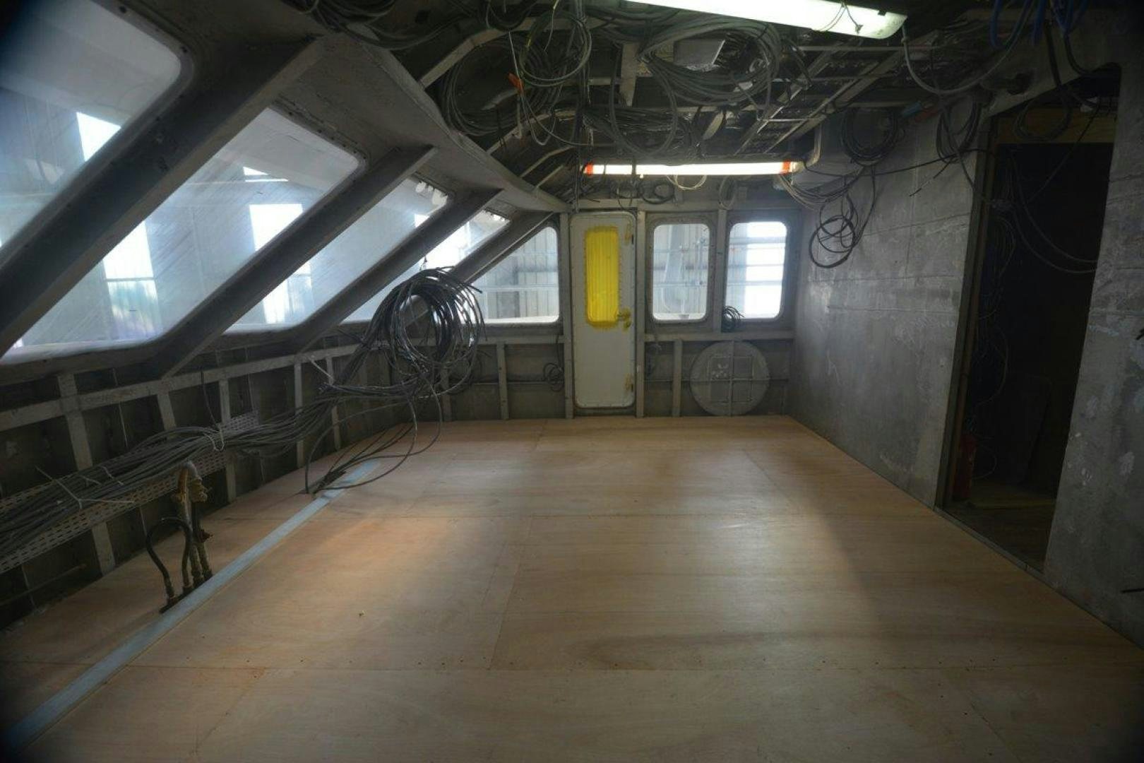 a room with a large wooden floor aboard MAGELLAN Yacht for Sale