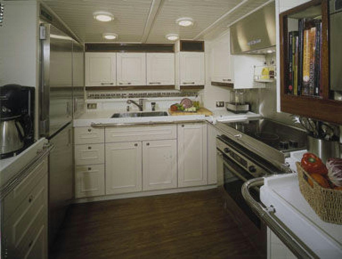 a kitchen with white cabinets aboard RANGER Yacht for Sale