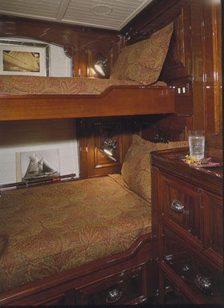 a bed with a wooden headboard aboard RANGER Yacht for Sale