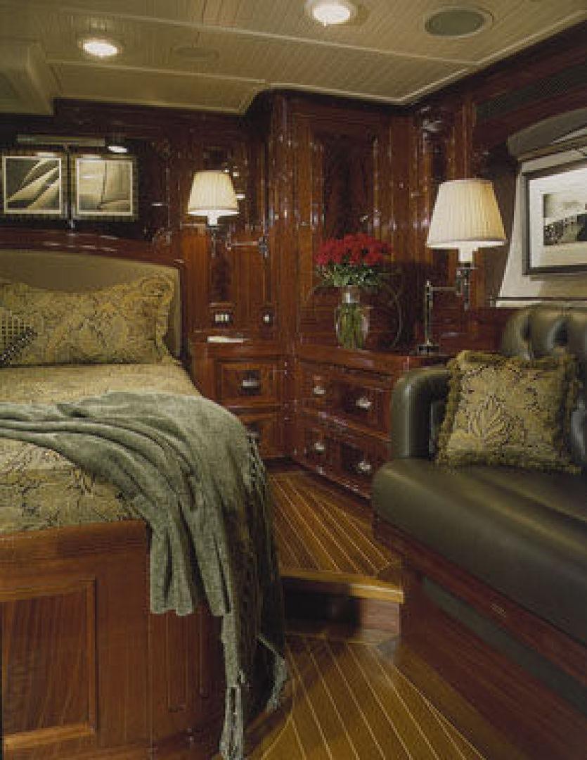 a bedroom with a bed and a couch aboard RANGER Yacht for Sale
