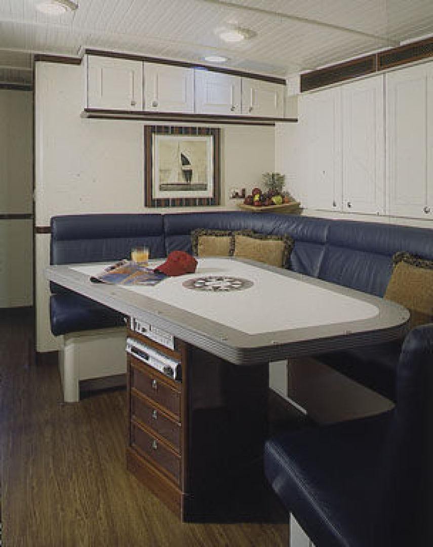 a kitchen with a blue couch aboard RANGER Yacht for Sale