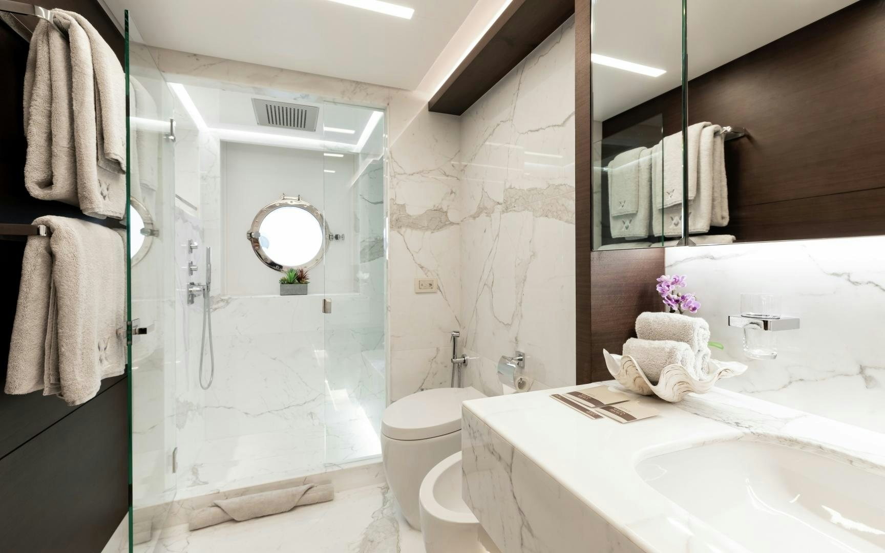 a bathroom with a sink toilet and a mirror aboard ALTAVITA Yacht for Sale