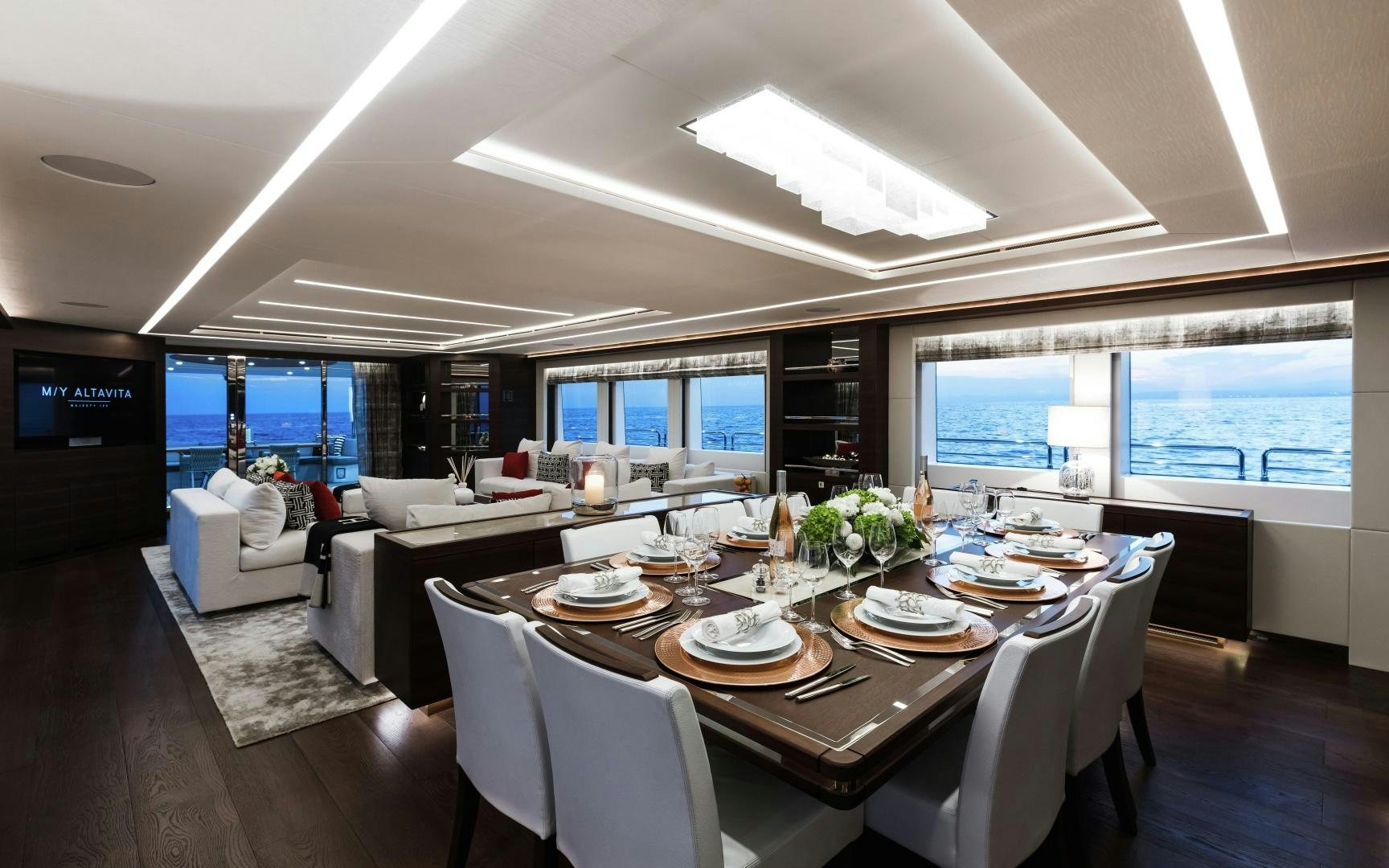 a dining room with a large window aboard ALTAVITA Yacht for Sale