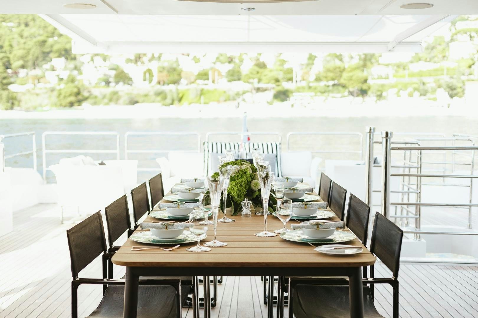 a table set with plates and glasses aboard ALTAVITA Yacht for Sale