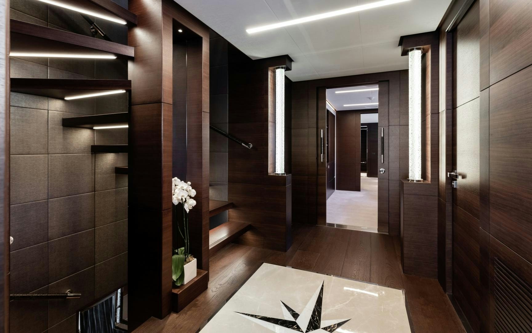 a room with a large mirror and a counter with a vase of flowers aboard ALTAVITA Yacht for Sale