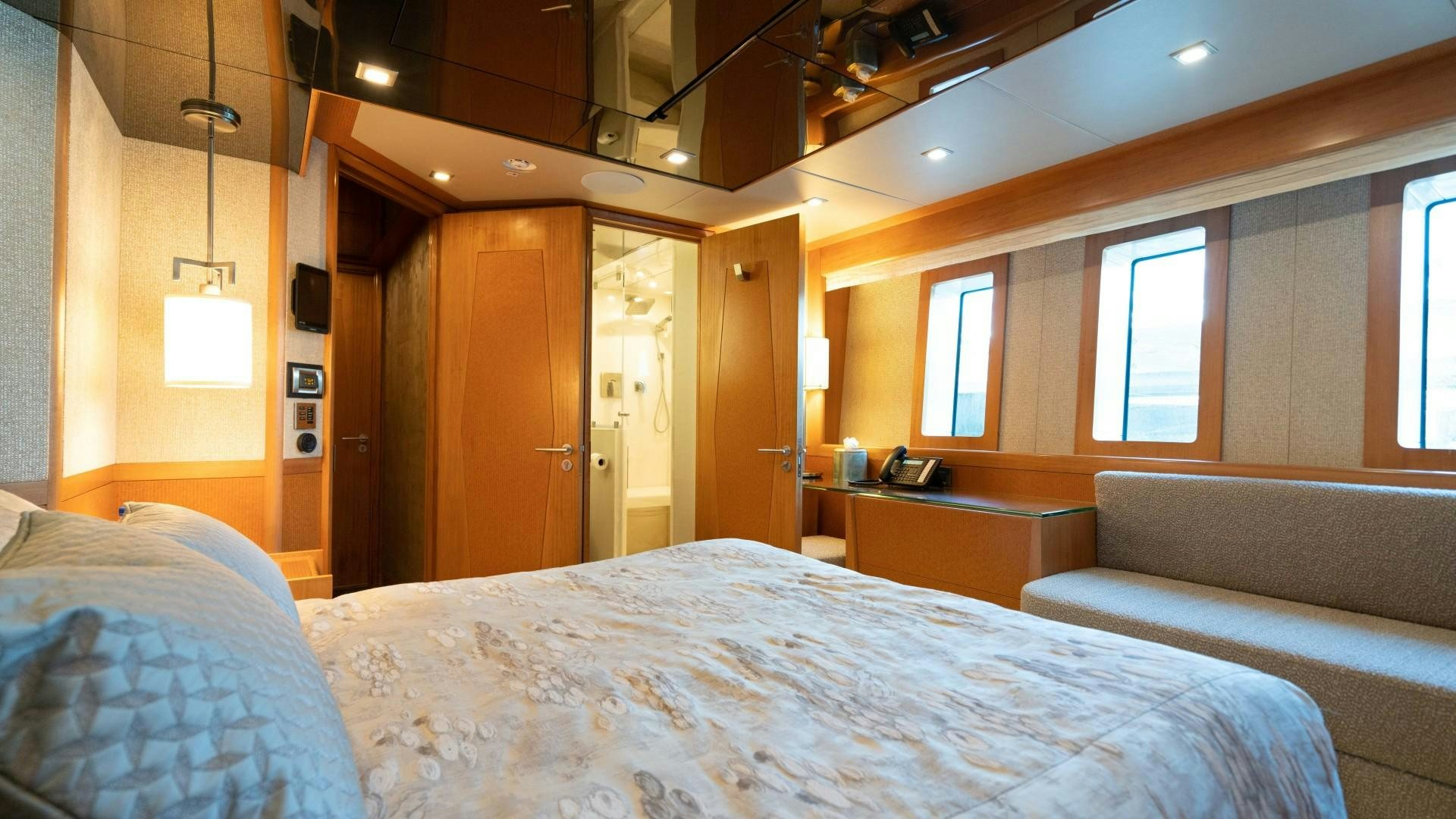 a room with a bed and a desk aboard SERENITY Yacht for Sale