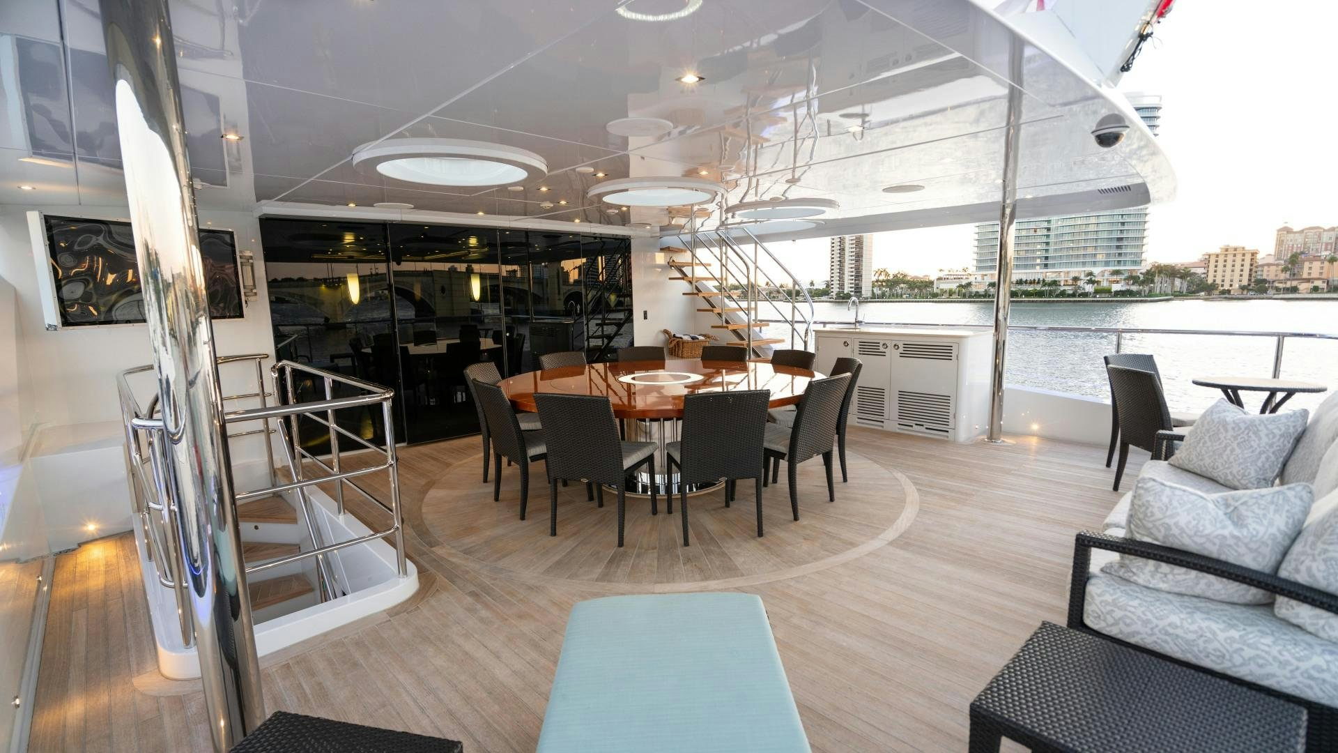 a large room with a table and chairs and a couch aboard SERENITY Yacht for Sale