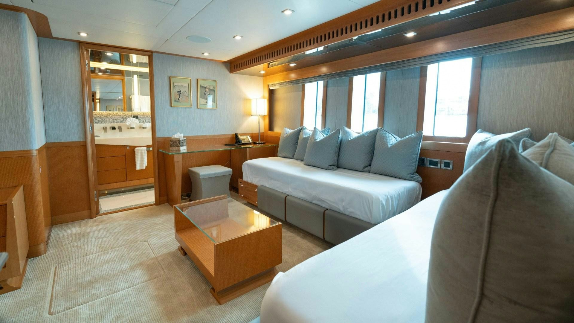 a large living room with a couch and a table aboard SERENITY Yacht for Sale