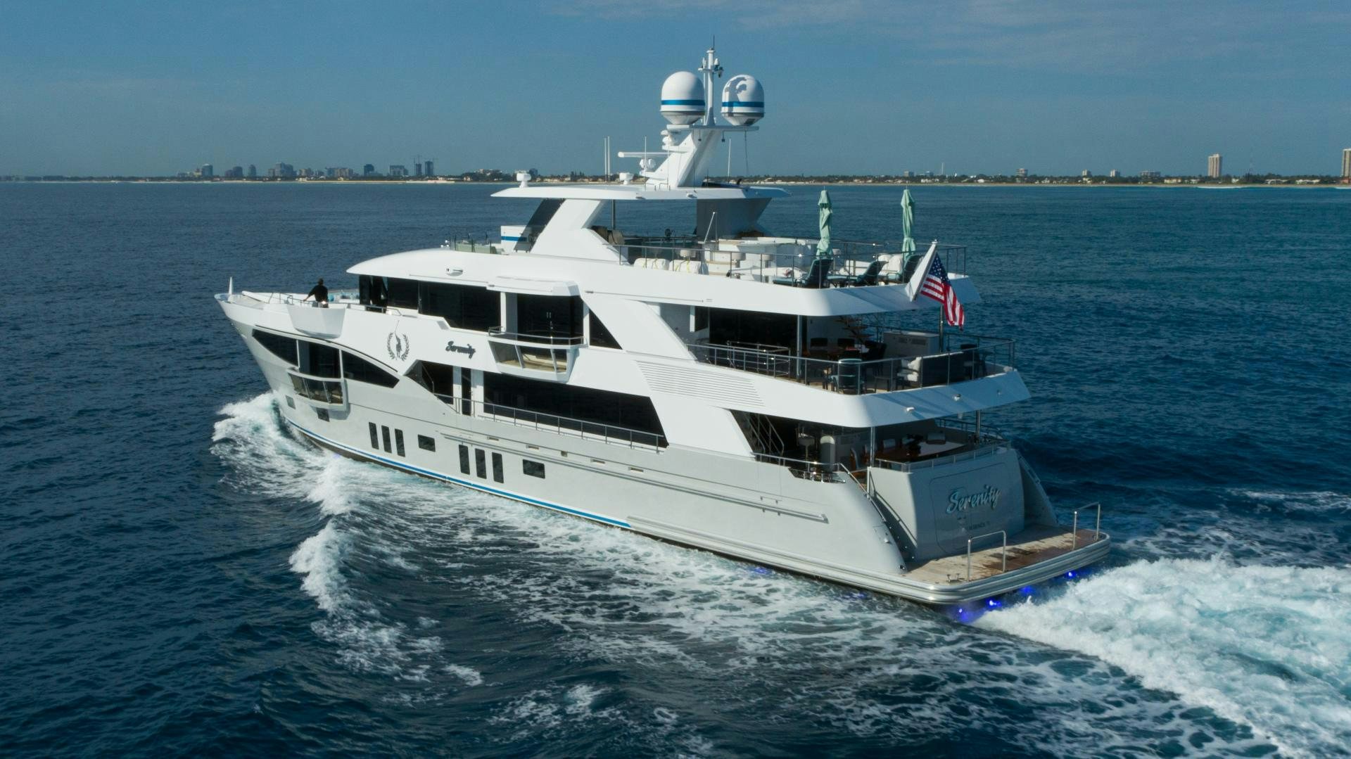 a large white boat on the water aboard SERENITY Yacht for Sale