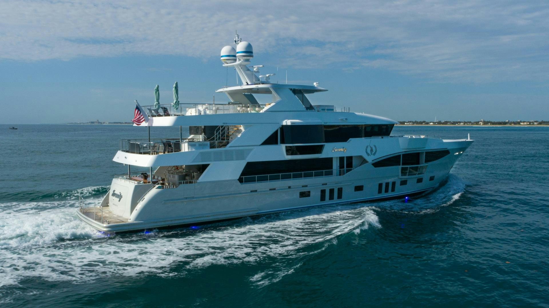 a large white boat on the water aboard SERENITY Yacht for Sale