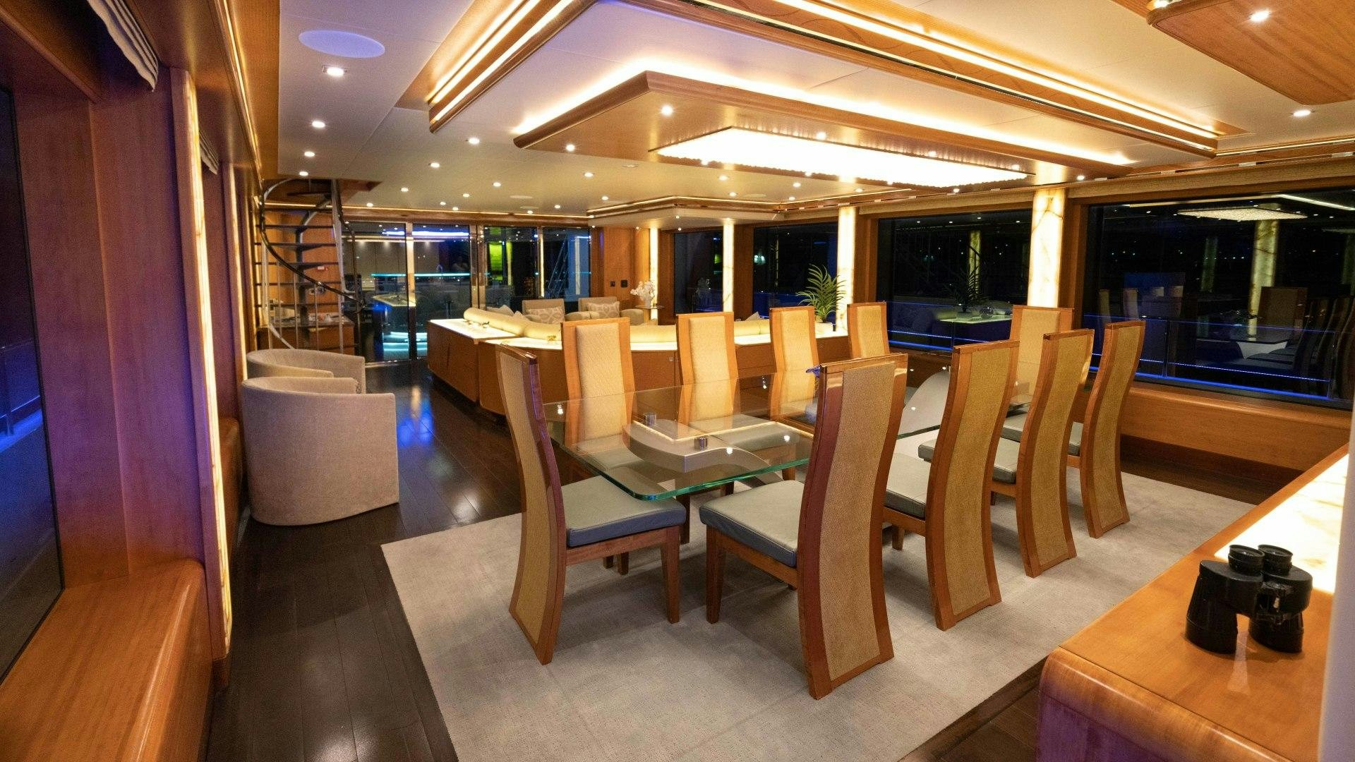 a room with chairs and tables aboard SERENITY Yacht for Sale