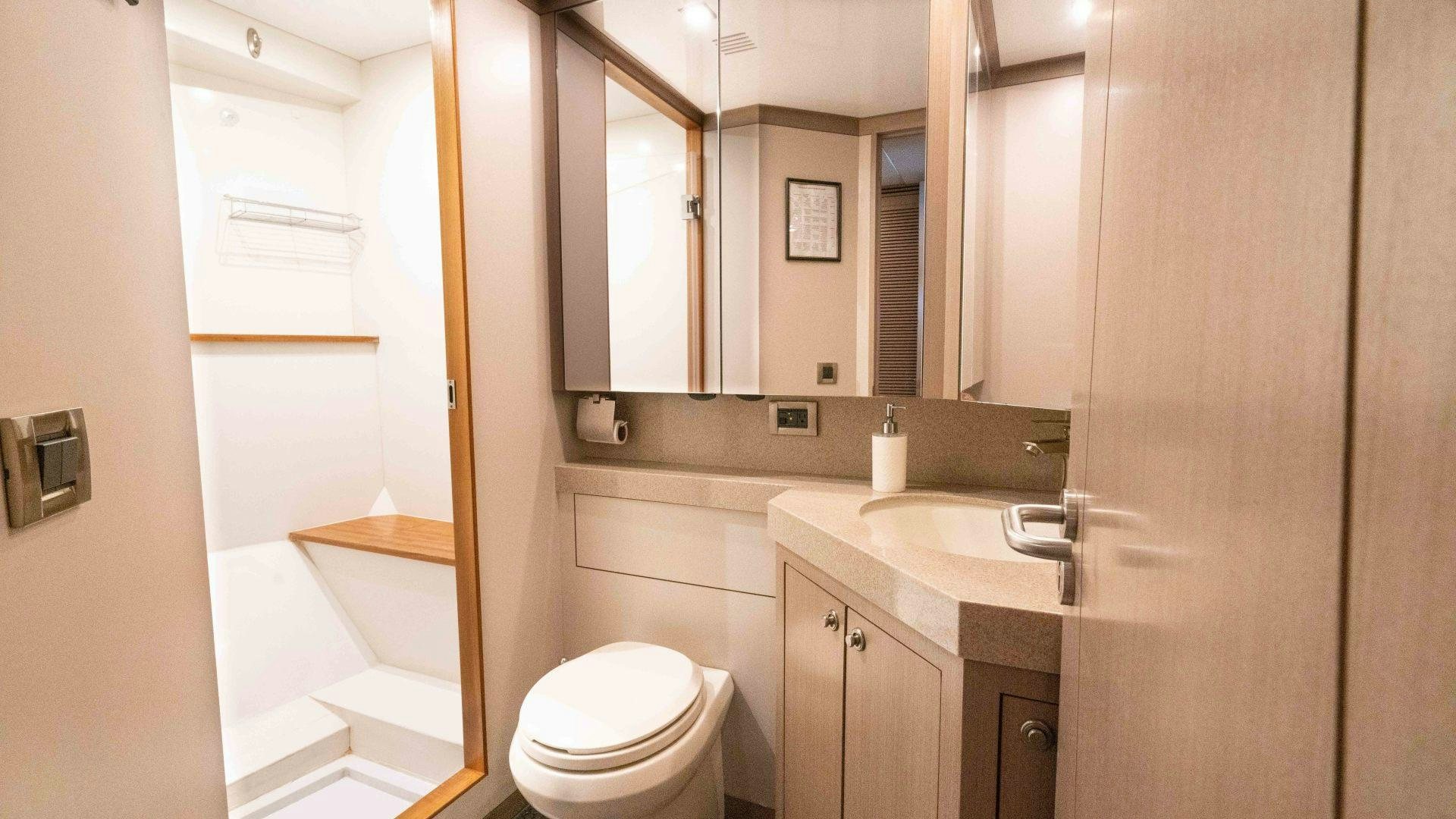 a bathroom with a toilet and a sink aboard SERENITY Yacht for Sale