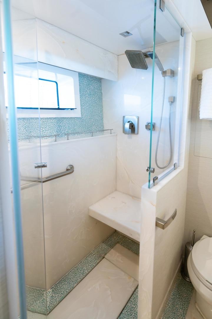 a bathroom with a shower and a toilet aboard SERENITY Yacht for Sale