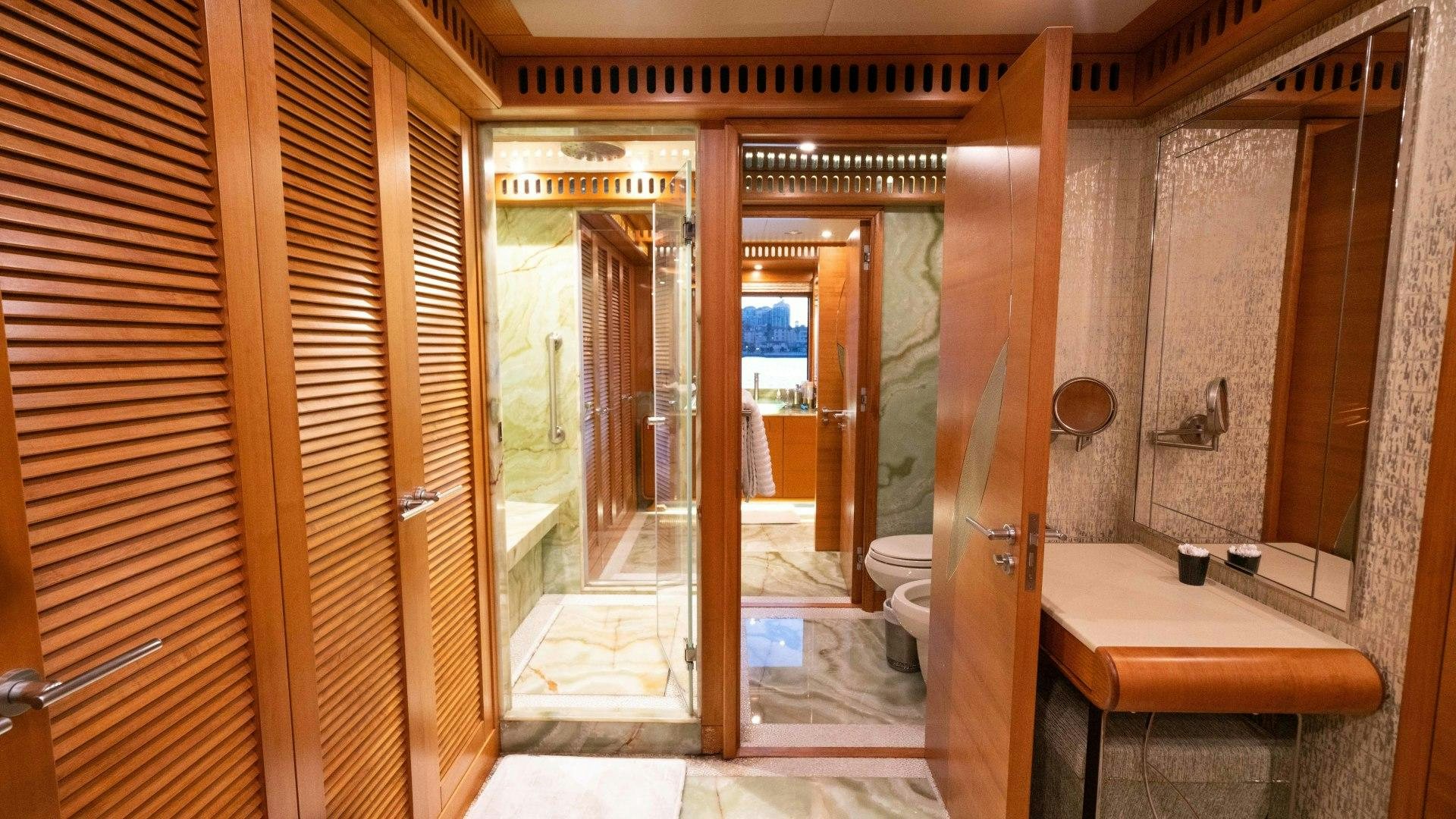 a bathroom with a glass shower aboard SERENITY Yacht for Sale