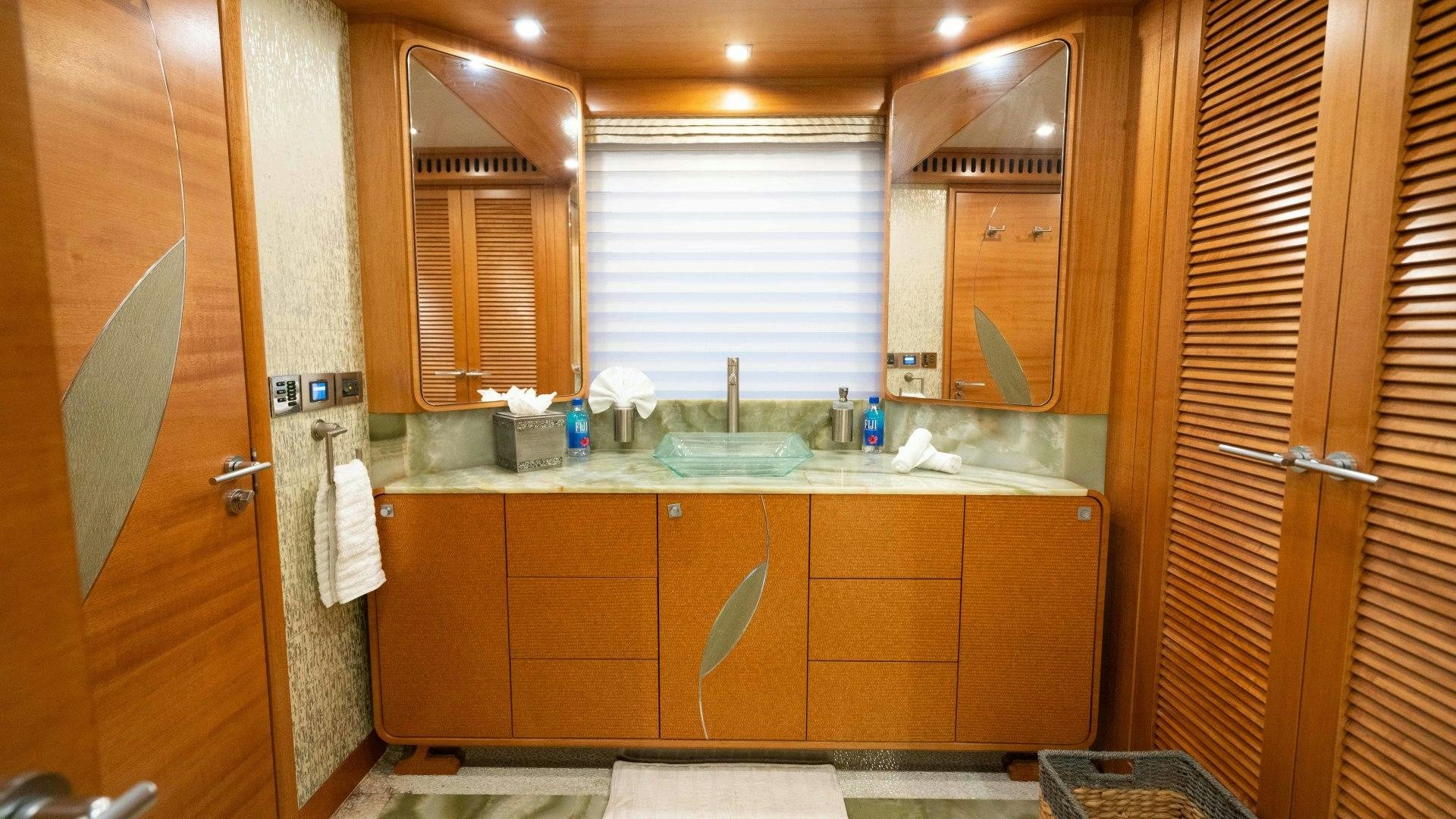 a bathroom with a sink and cabinets aboard SERENITY Yacht for Sale
