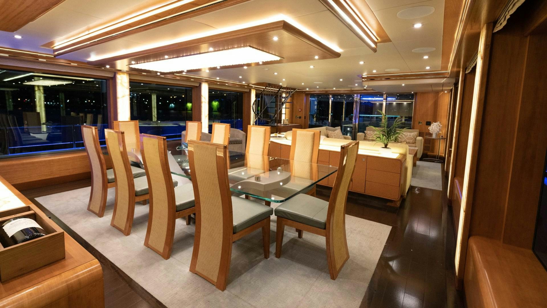 a room with tables and chairs aboard SERENITY Yacht for Sale