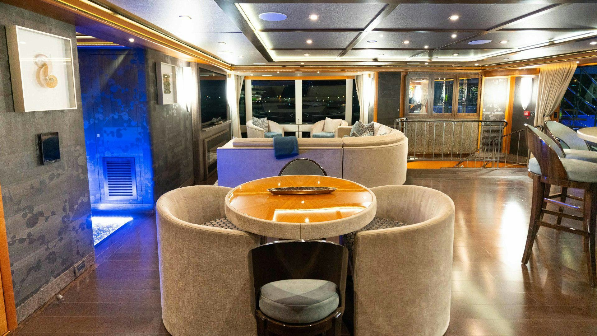 a room with a table and chairs aboard SERENITY Yacht for Sale