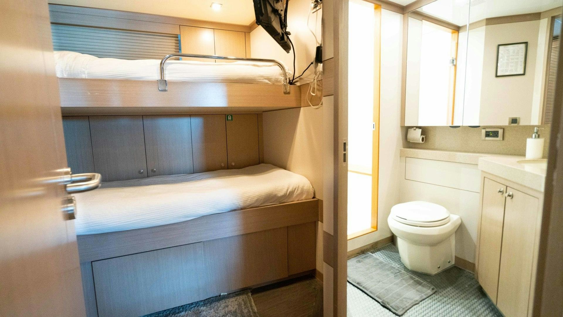 a bathroom with a tub toilet and sink aboard SERENITY Yacht for Sale