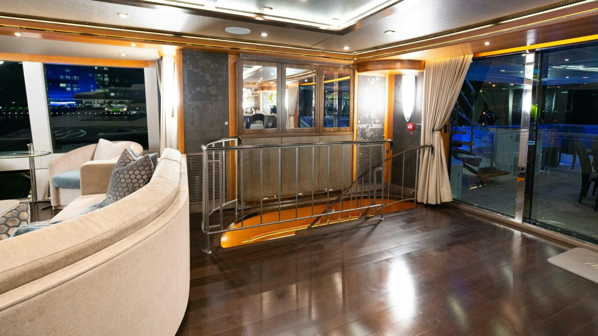 a room with a couch and a railing aboard SERENITY Yacht for Sale