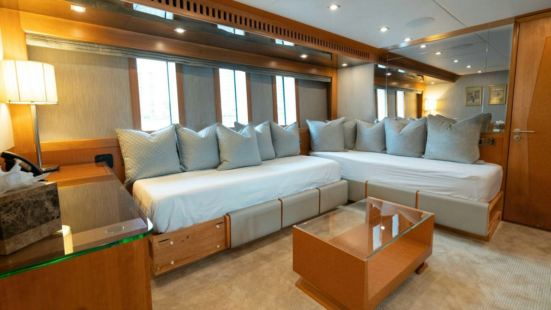 a large living room with a large bed and a table aboard SERENITY Yacht for Sale
