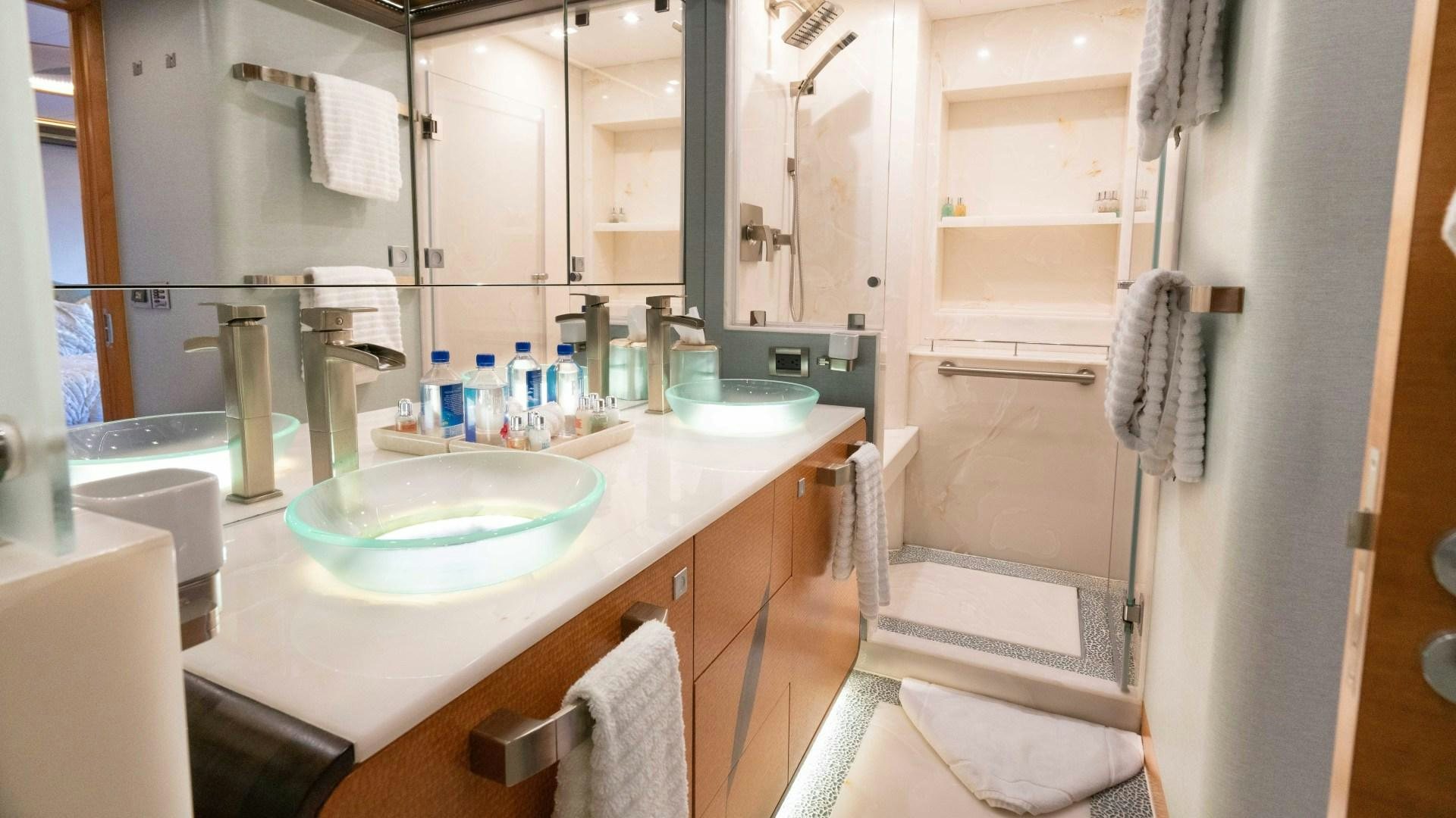 a bathroom with a sink and a mirror aboard SERENITY Yacht for Sale