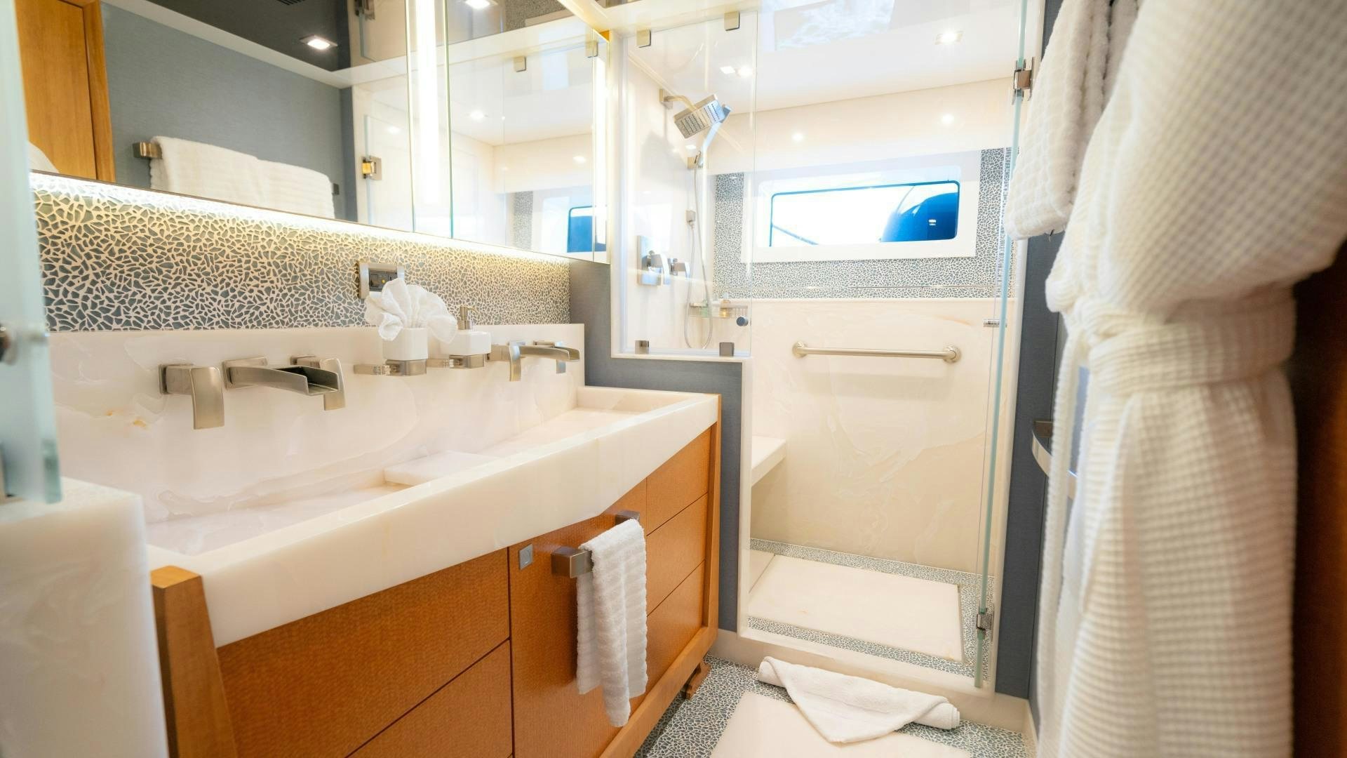 a bathroom with a sink and a mirror aboard SERENITY Yacht for Sale
