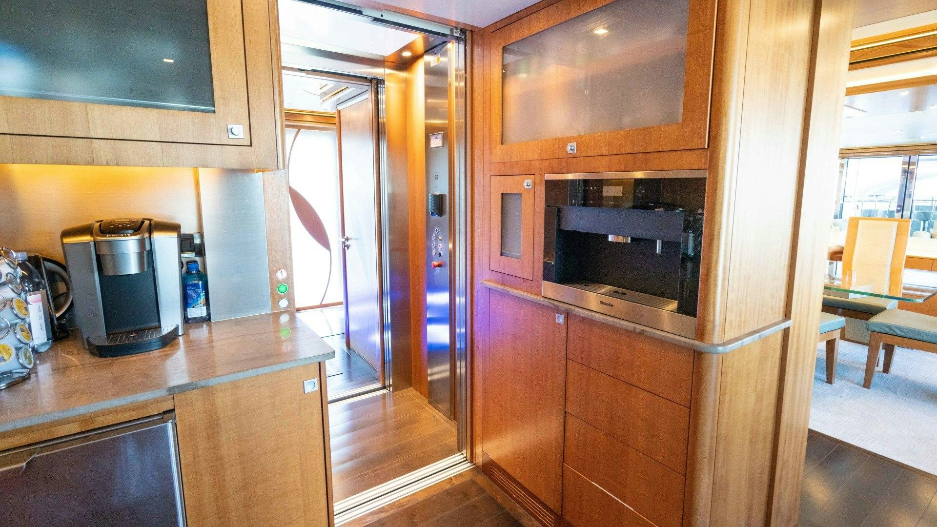 a kitchen with wooden cabinets aboard SERENITY Yacht for Sale