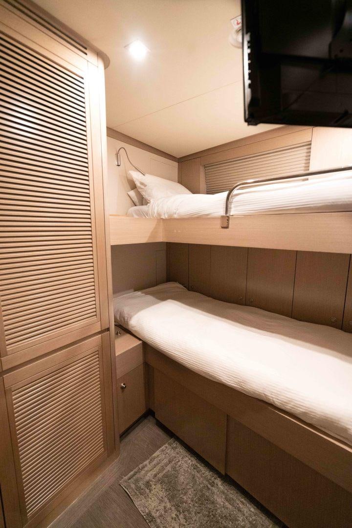 a person's legs on a bed aboard SERENITY Yacht for Sale