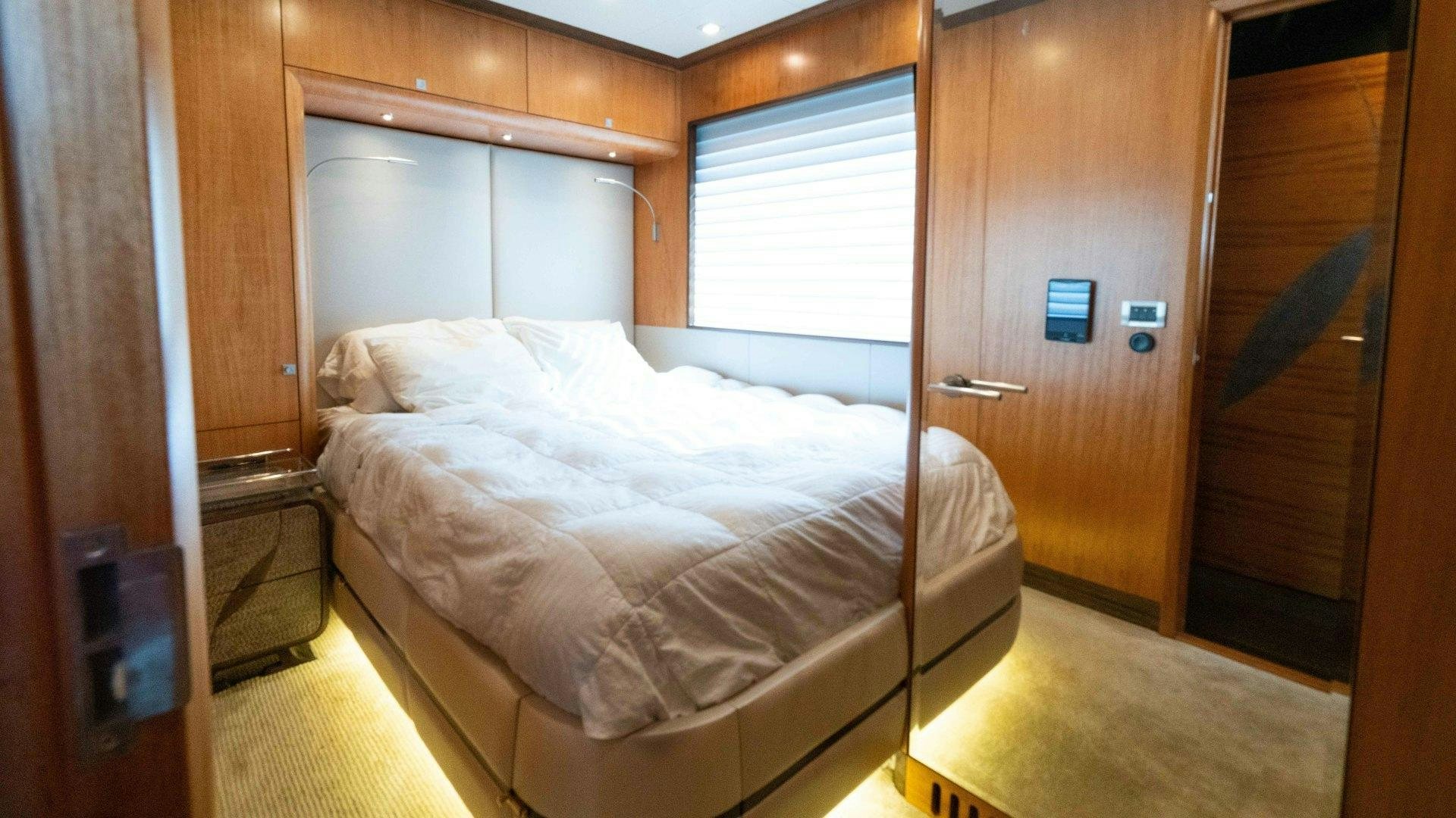 a room with a bed and a closet aboard SERENITY Yacht for Sale