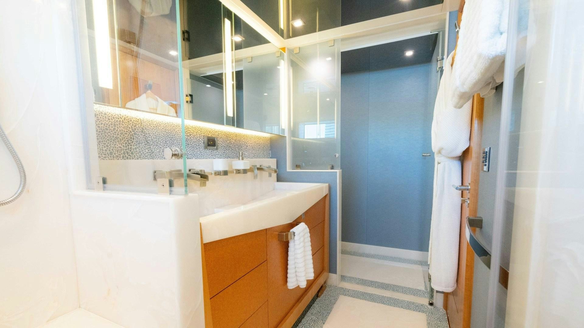 a bathroom with a sink and a mirror aboard SERENITY Yacht for Sale