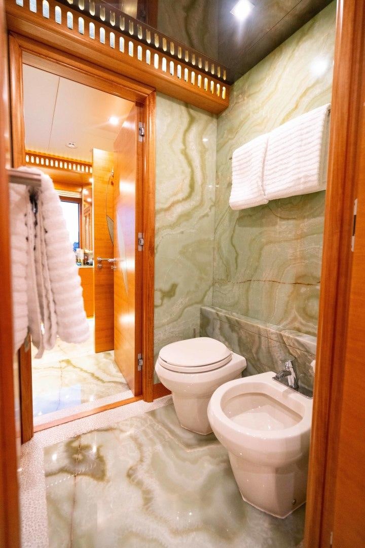 a bathroom with a toilet and a sink aboard SERENITY Yacht for Sale