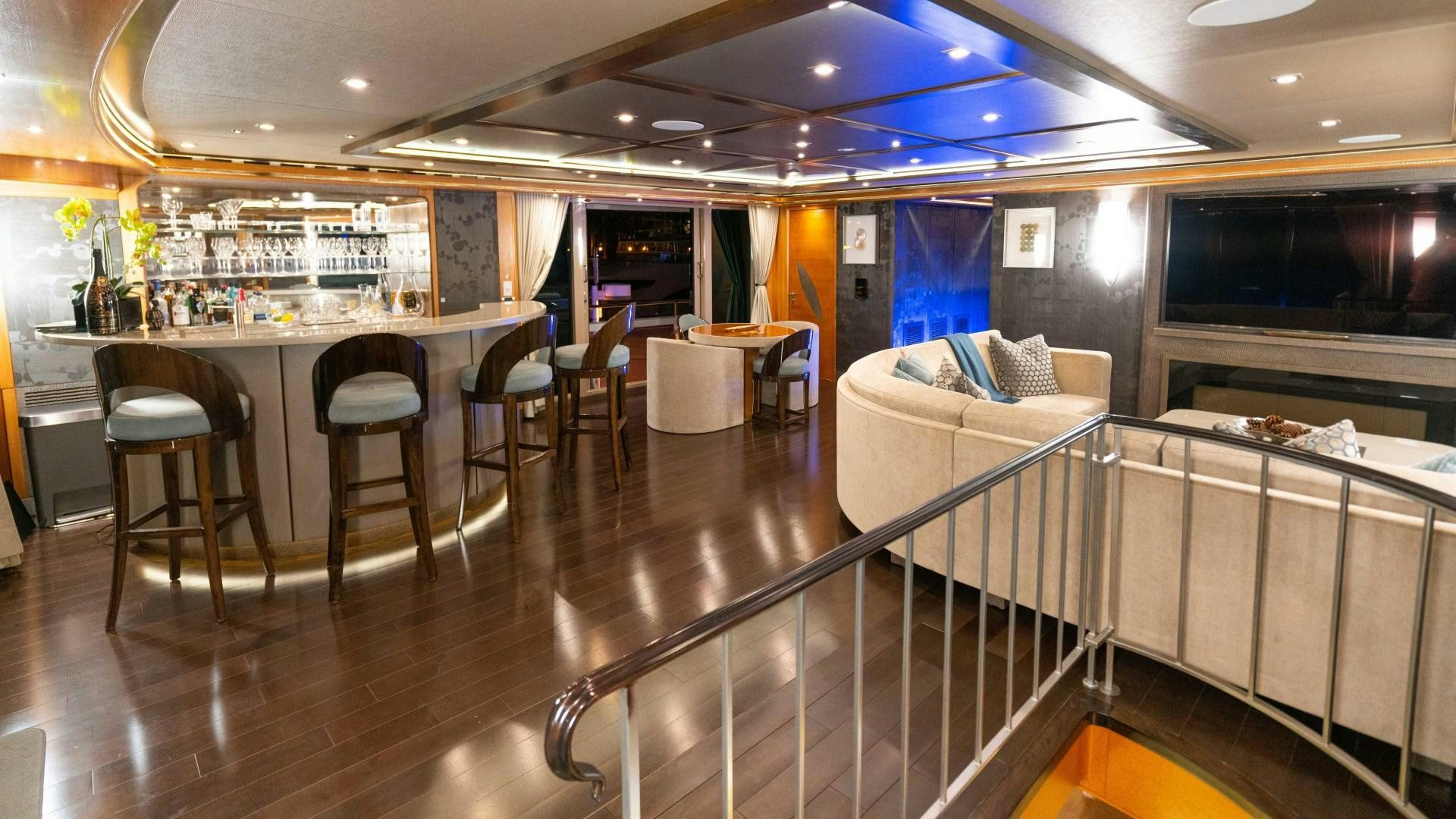 a large room with a table and chairs aboard SERENITY Yacht for Sale