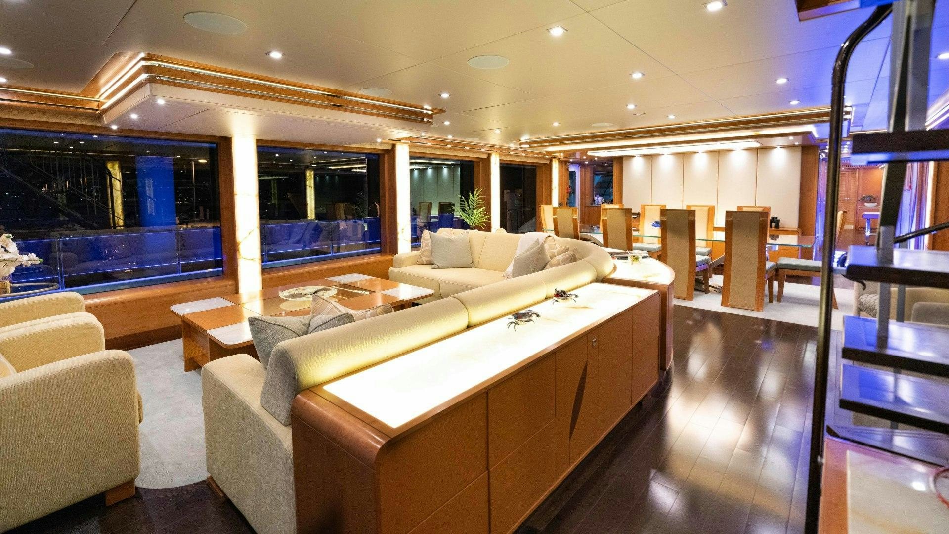 a large living room with a large window aboard SERENITY Yacht for Sale