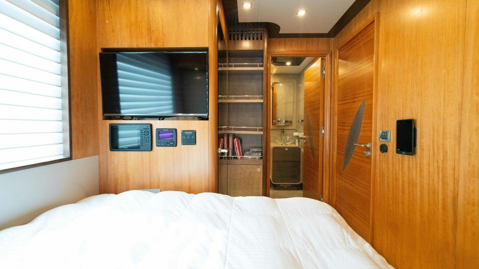a room with a bed and a television aboard SERENITY Yacht for Sale