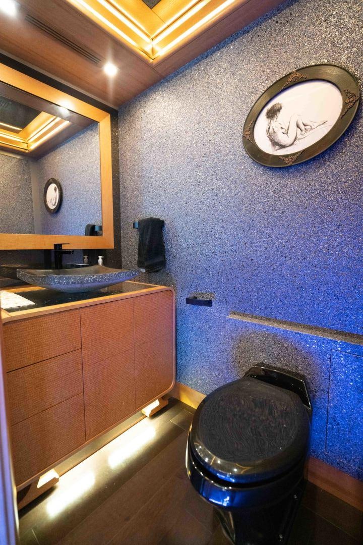 a bathroom with a round mirror aboard SERENITY Yacht for Sale