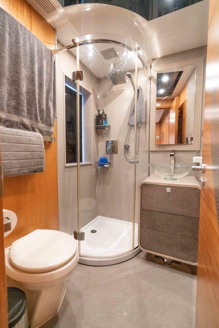 a bathroom with a shower and toilet aboard SERENITY Yacht for Sale