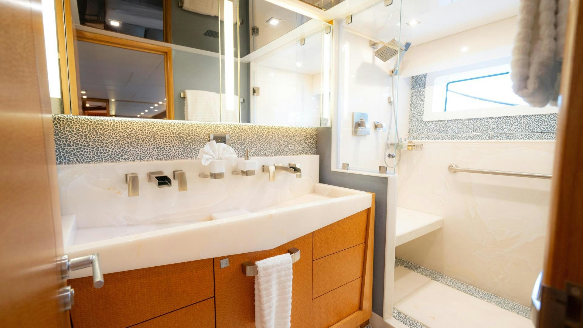 a bathroom with a sink and a mirror aboard SERENITY Yacht for Sale