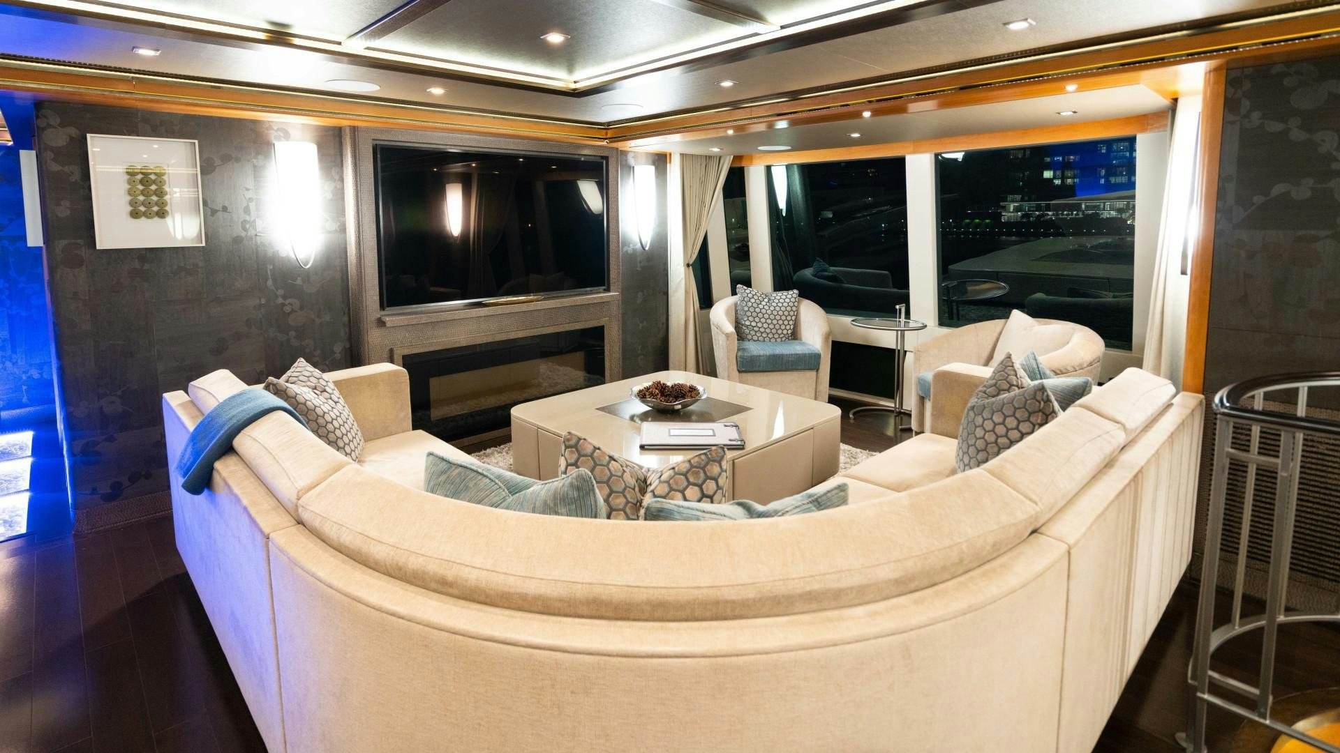 a living room with a couch and a television aboard SERENITY Yacht for Sale